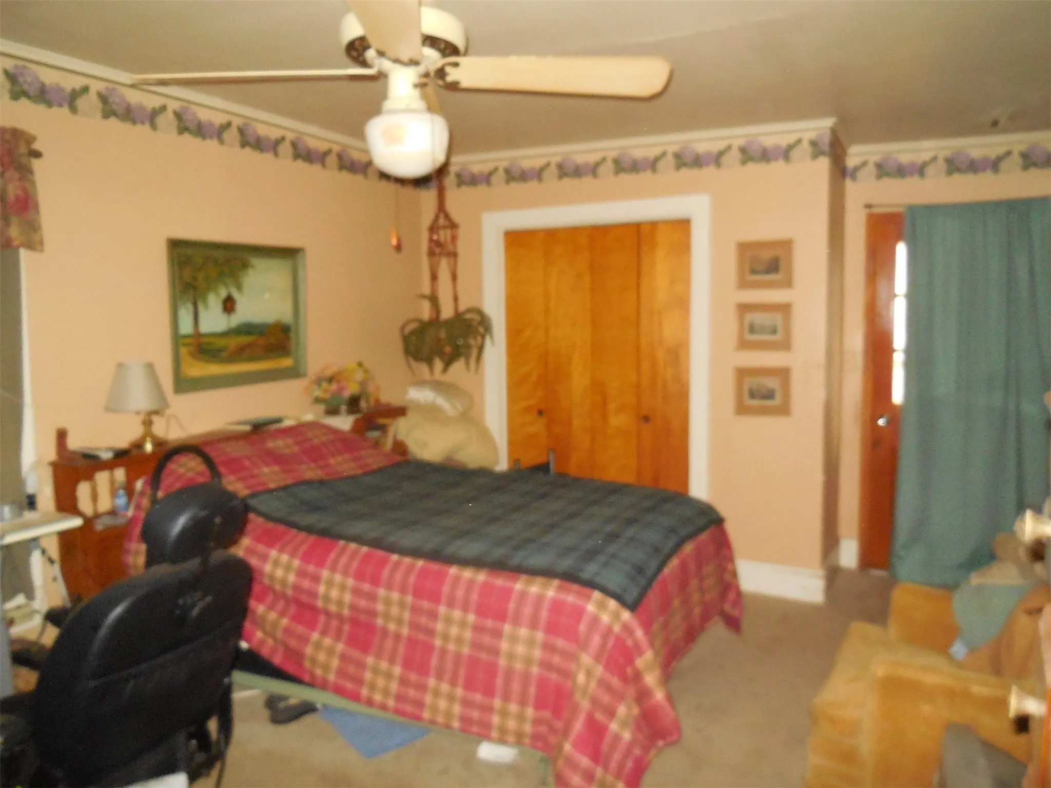 Carpeted bedroom featuring baseboards and a ceiling fan