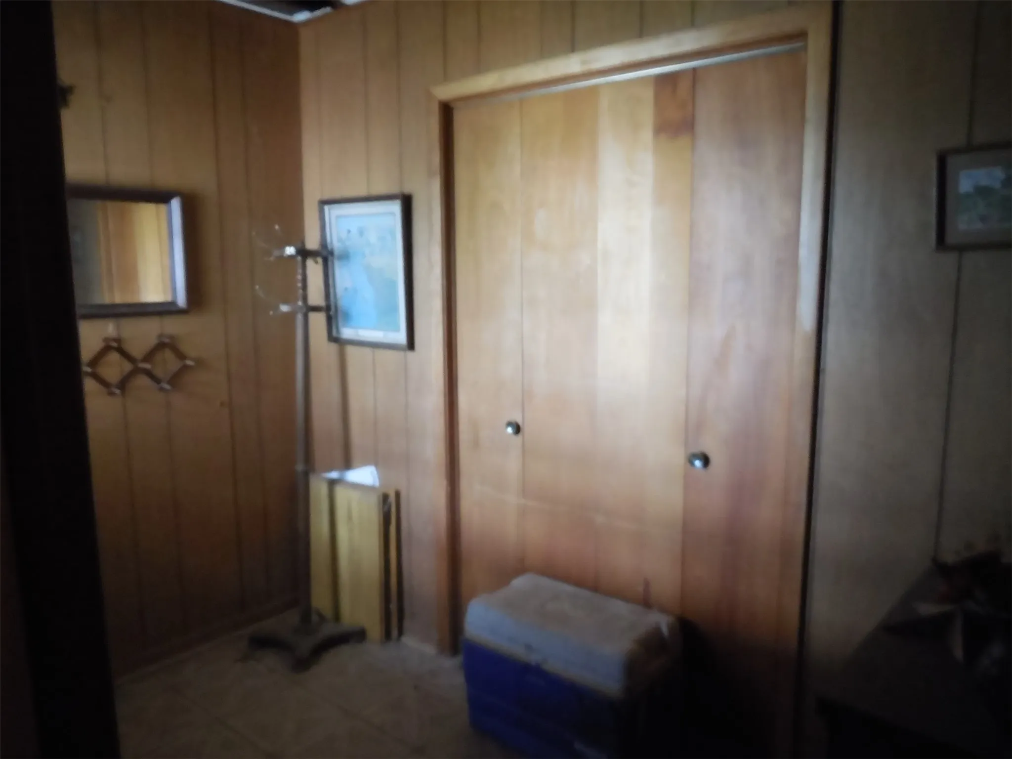 Entryway with wooden walls and storage