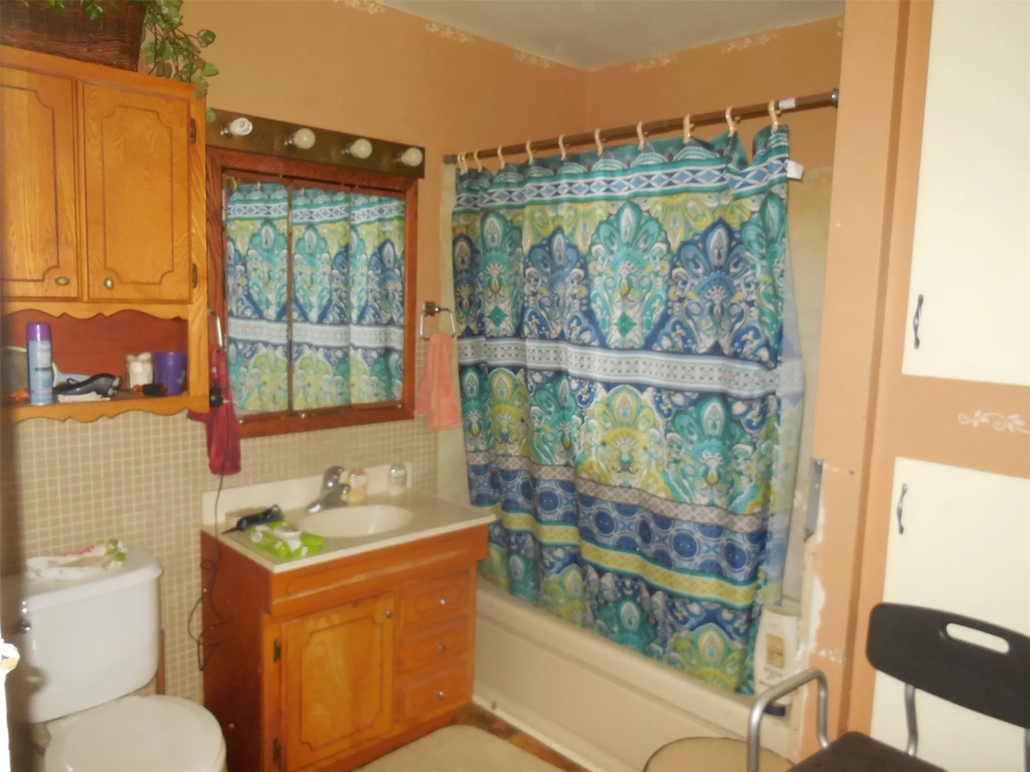 Full bath with toilet, shower / bath combination with curtain, and vanity