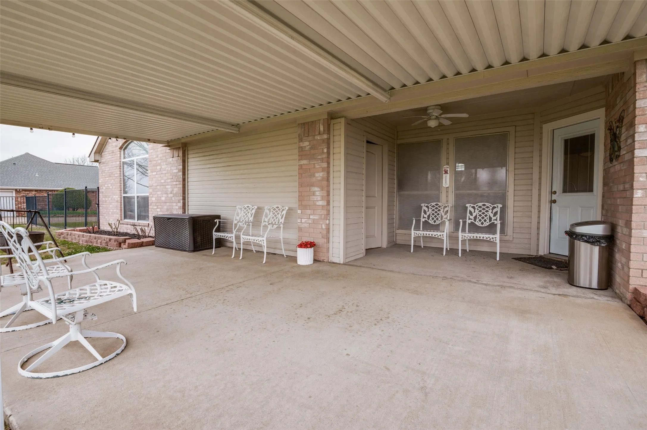 View of patio featuring fence and a ceiling fan