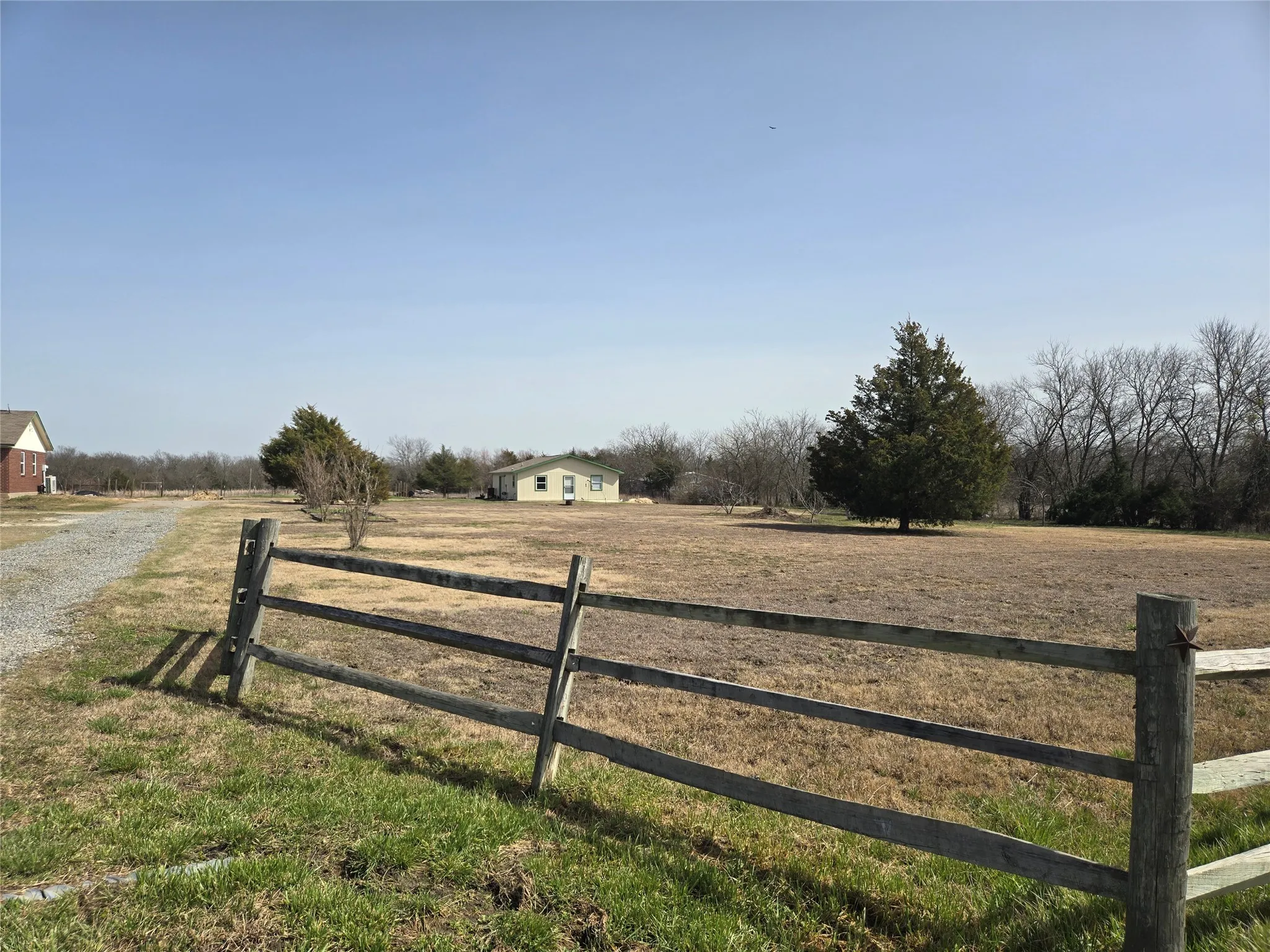 View of yard featuring a rural view and fence