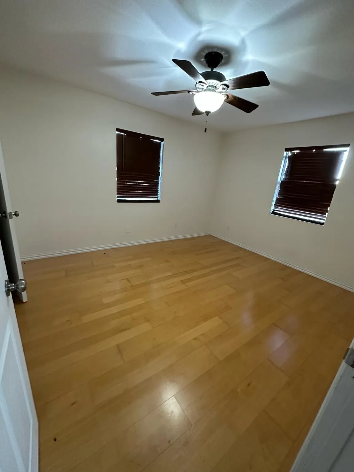  Barndo Unfurnished room featuring light wood-type flooring and ceiling fan