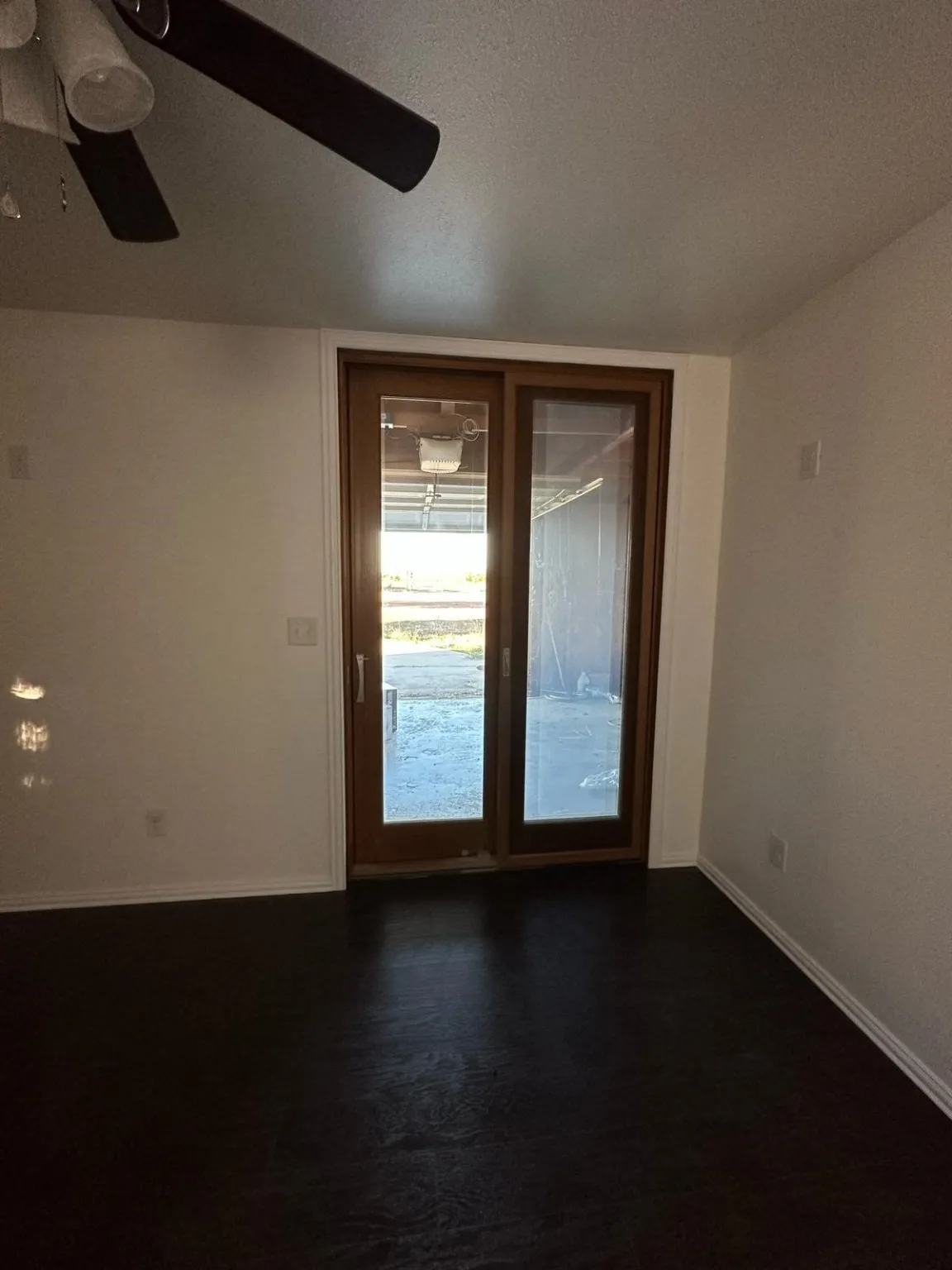 Unfurnished room featuring a textured ceiling and dark wood-style flooring
