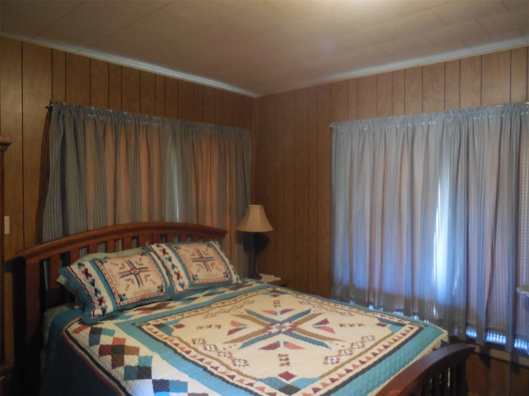 Bedroom featuring wood walls
