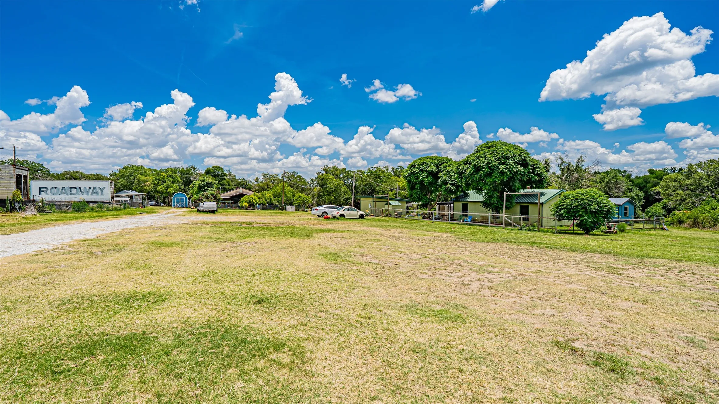 View of green lawn with driveway