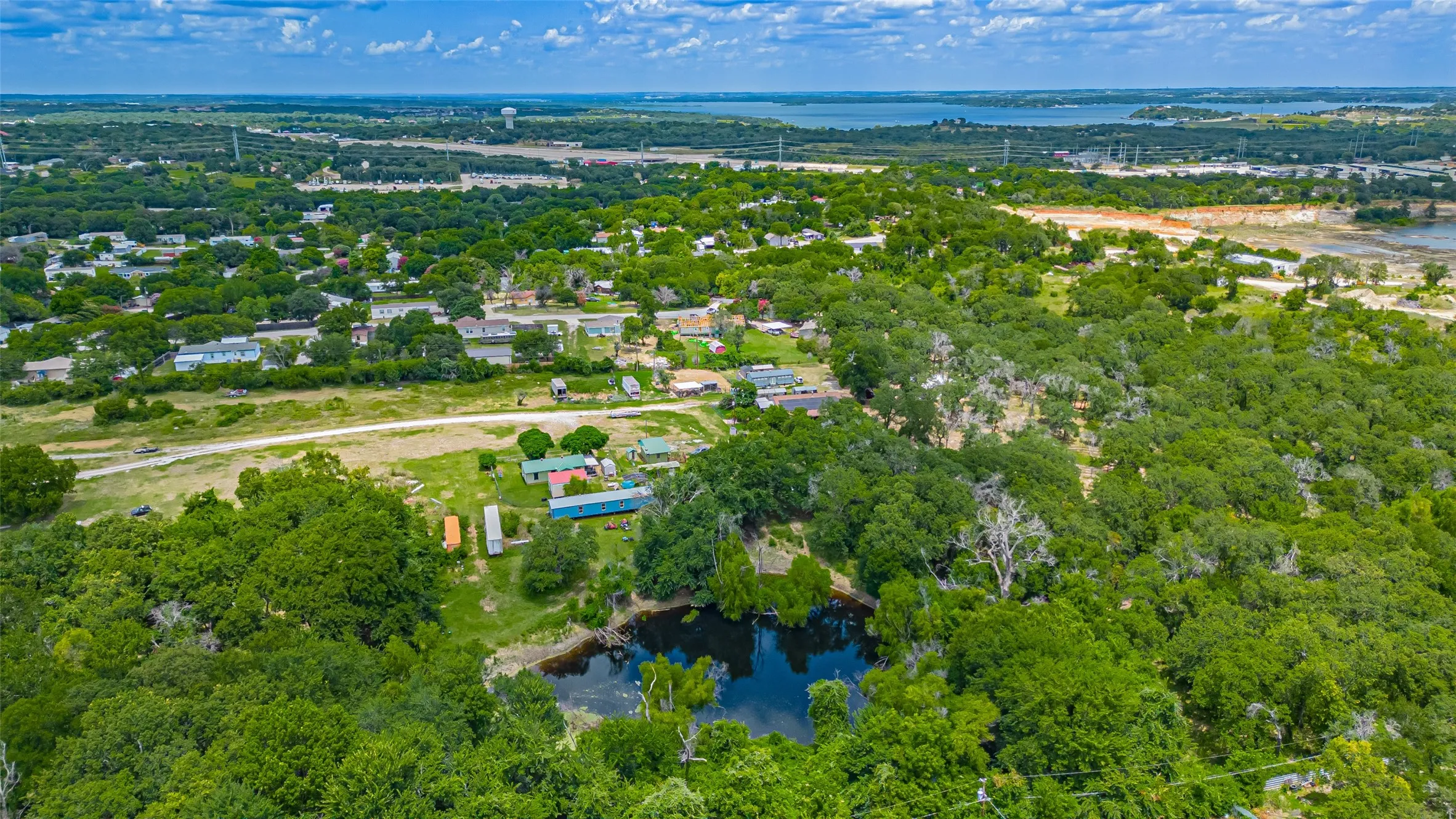 Aerial view of property and surrounding area featuring a large body of water