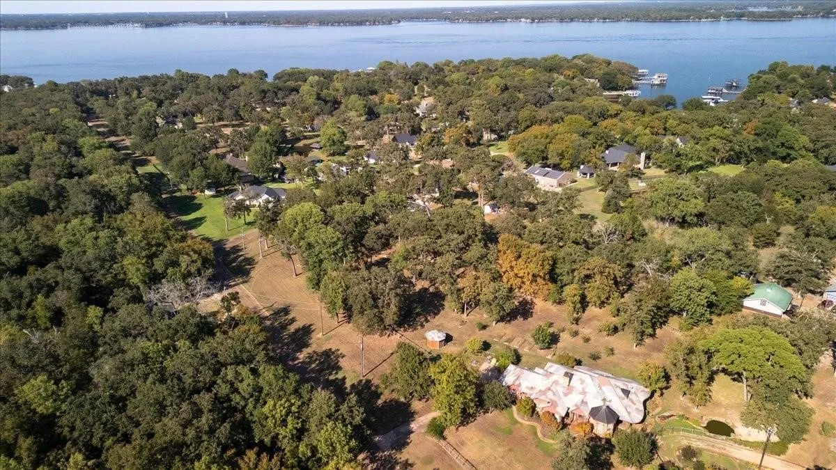 Drone / aerial view with a forest view and a water view