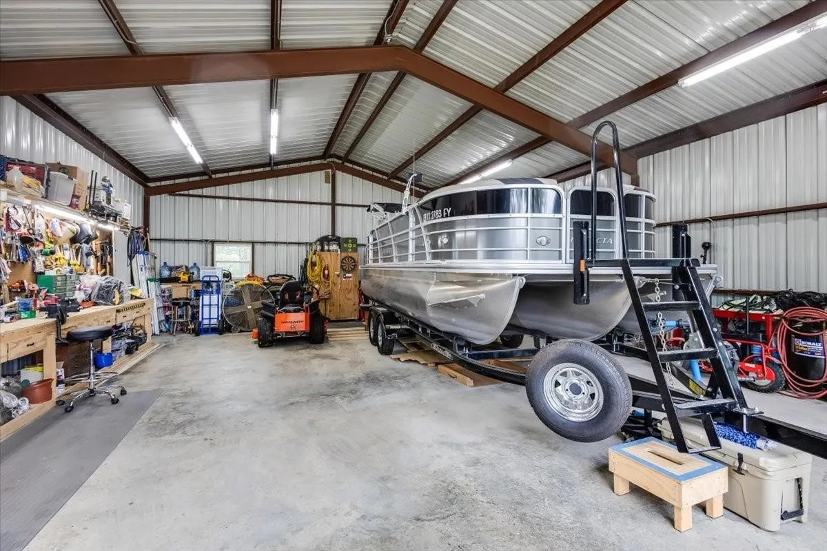 Garage with a workshop area and metal wall