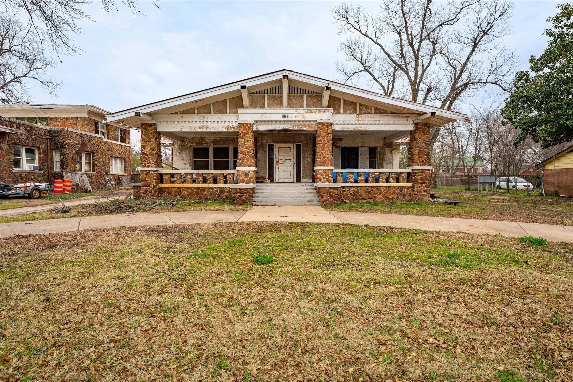 View of front of property with a porch and a front yard
