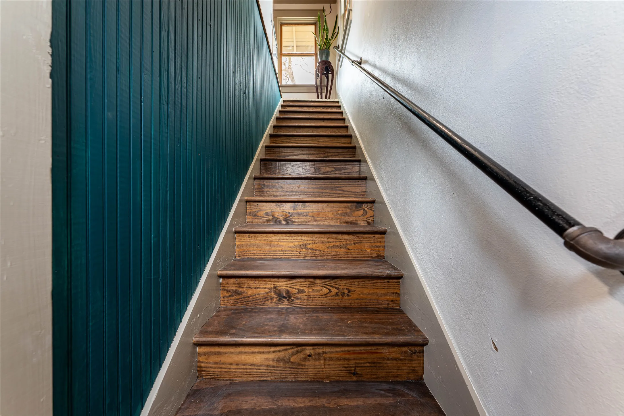 Staircase featuring a textured wall