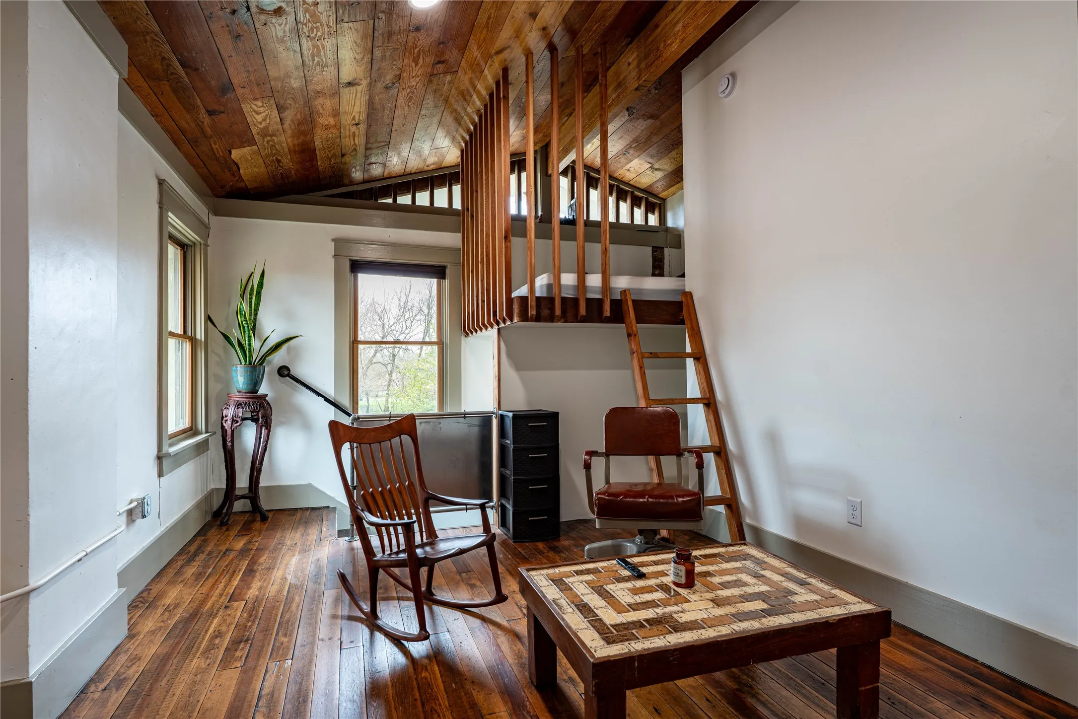 Living area featuring baseboards, wood ceiling, lofted ceiling, and wood-type flooring