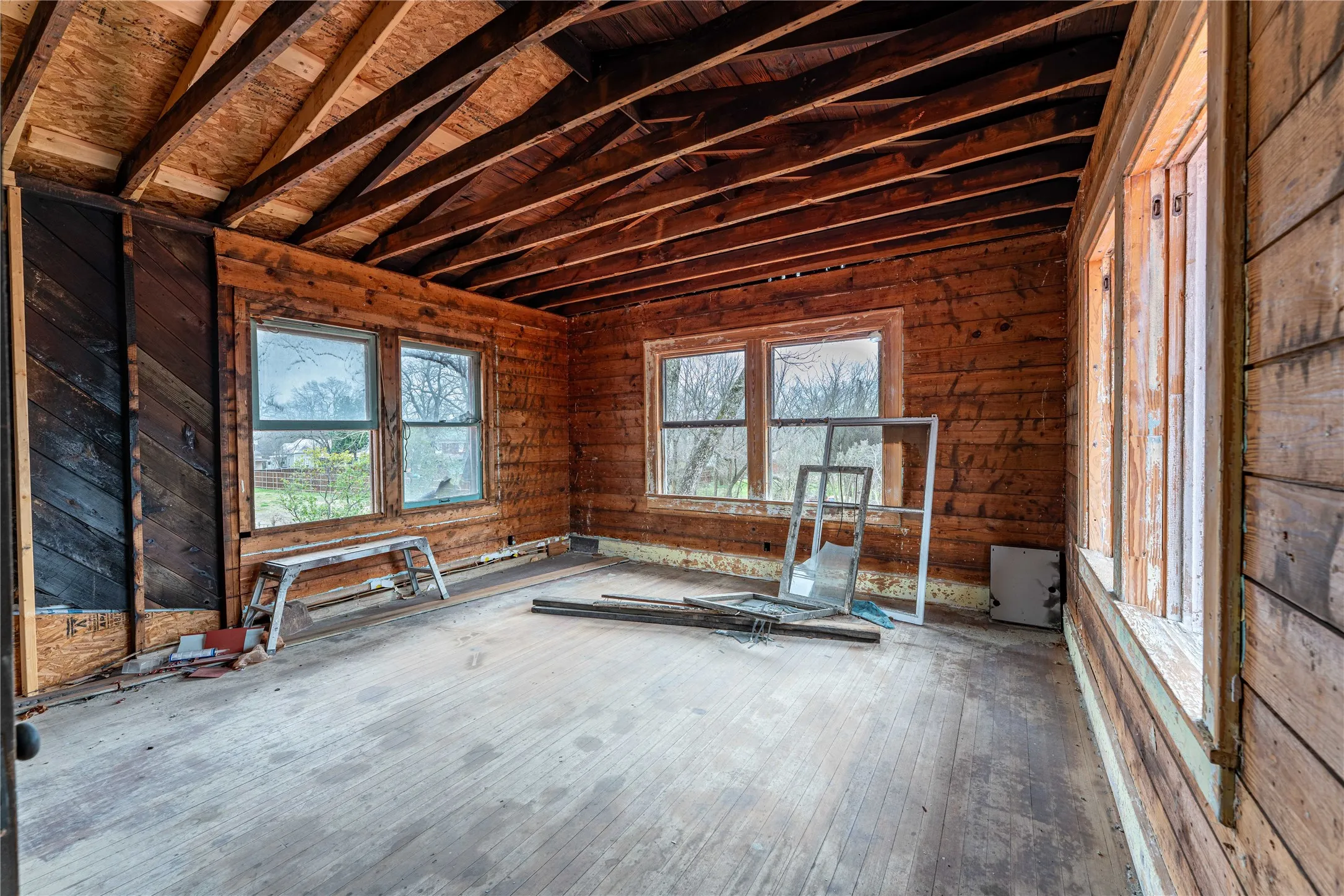 Unfurnished room with lofted ceiling and wood finished floors
