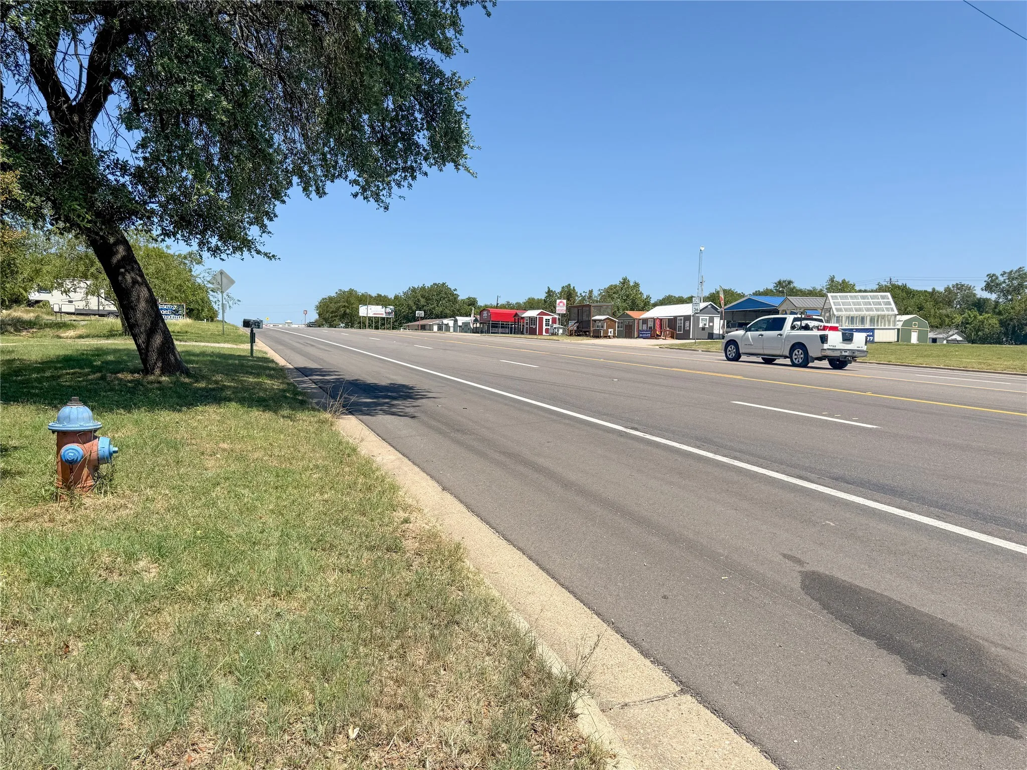 View of asphalt street with curbs