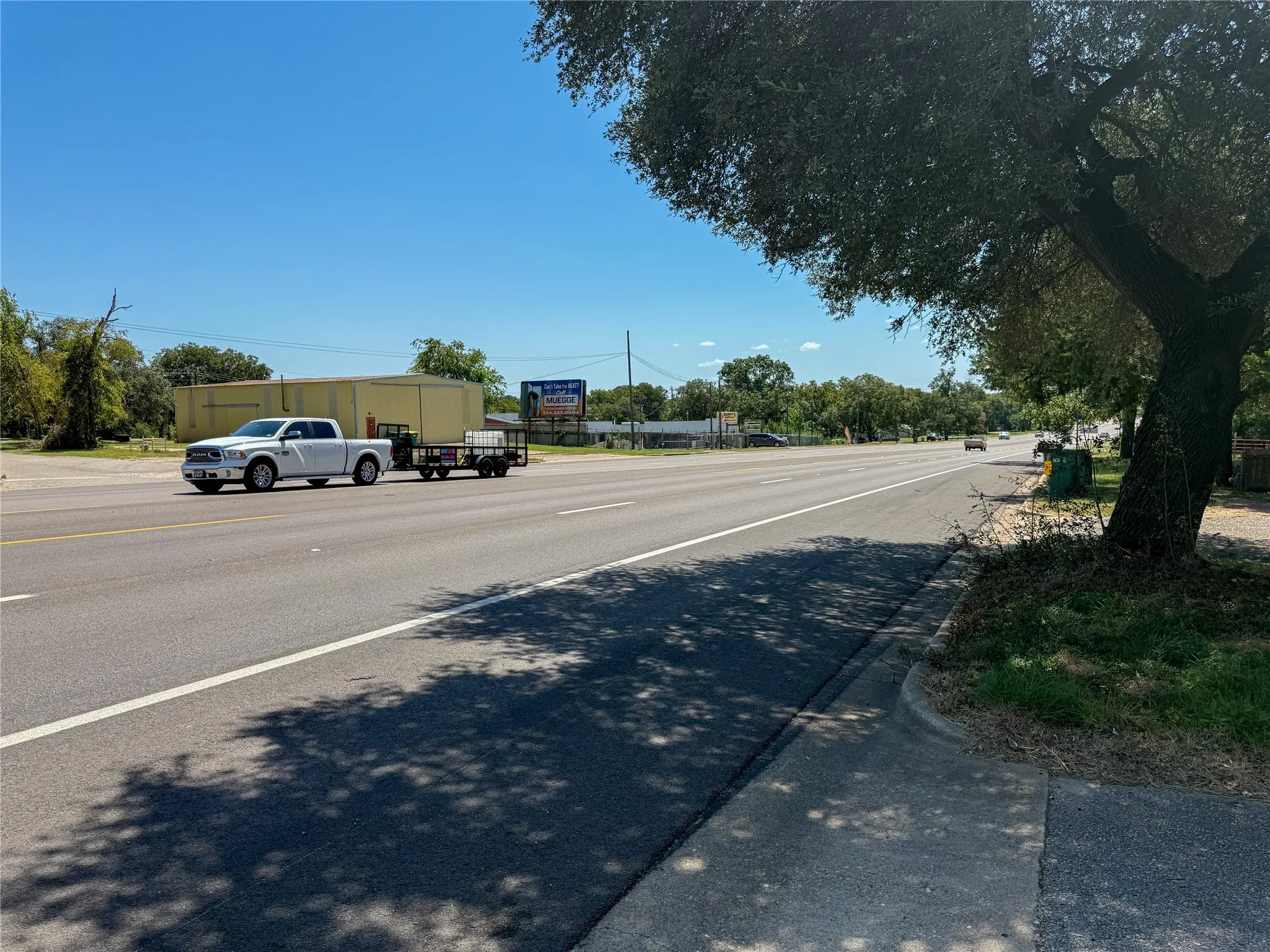 View of asphalt road with curbs