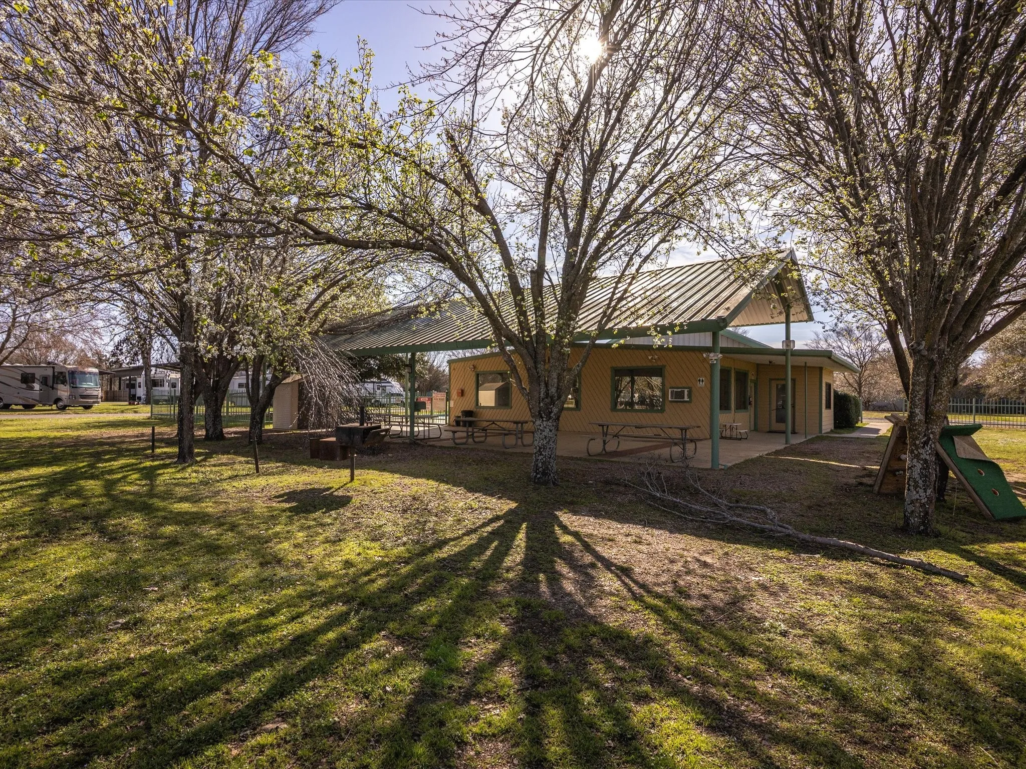 View of yard with a patio area, a playground, and fence