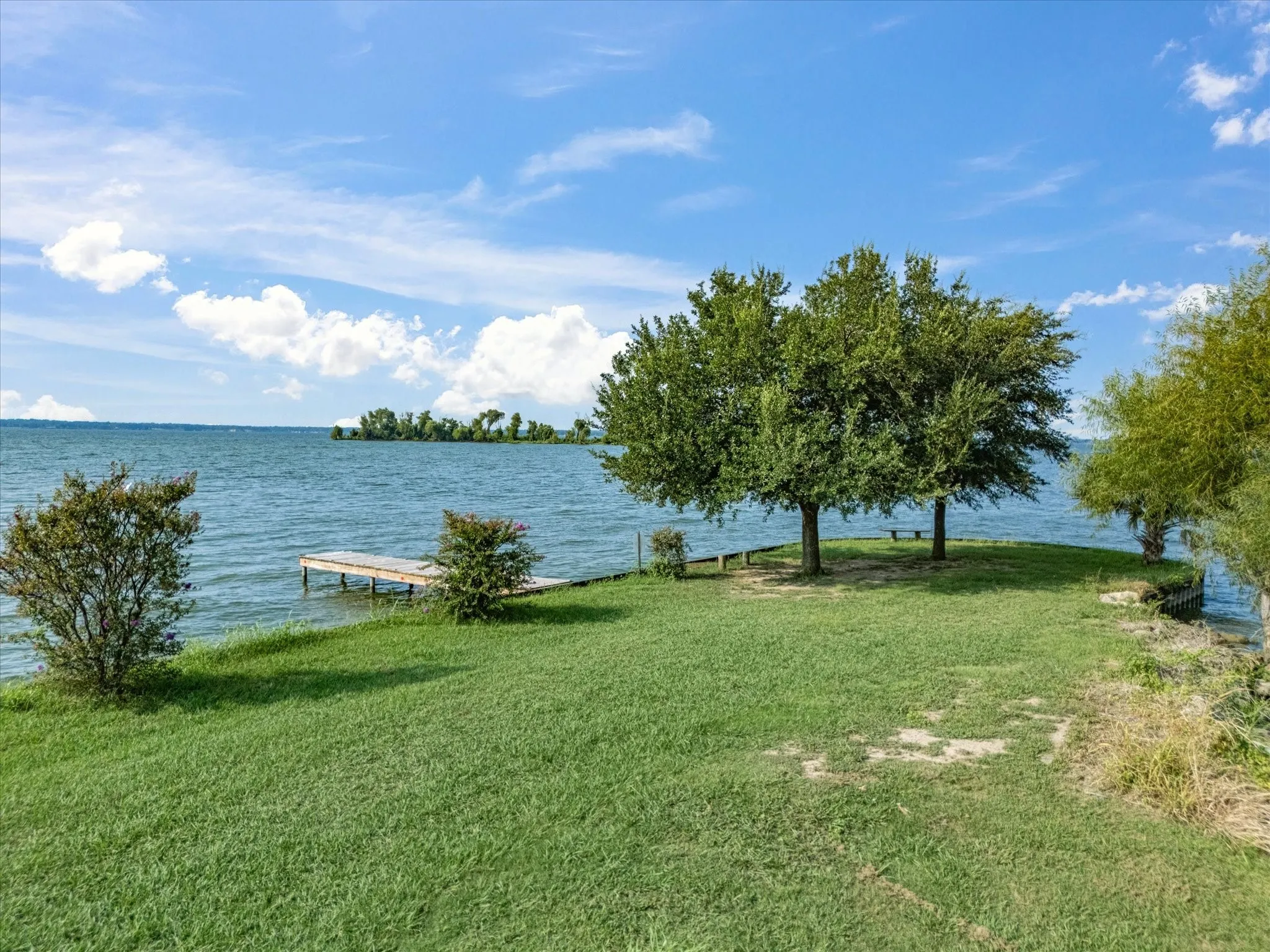 View of green lawn featuring a water view