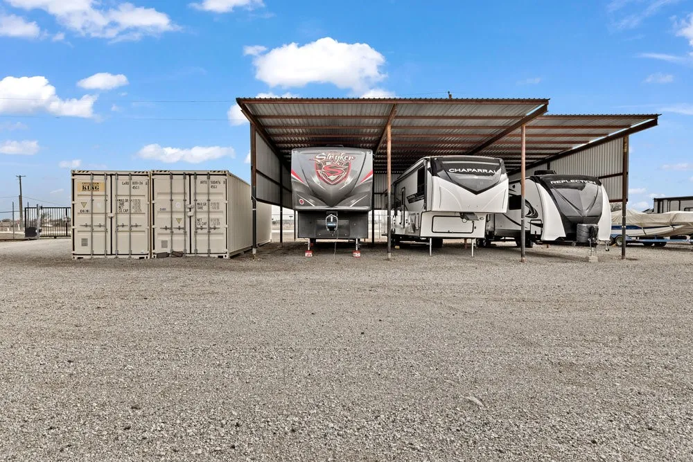 View of parking / parking lot featuring a carport