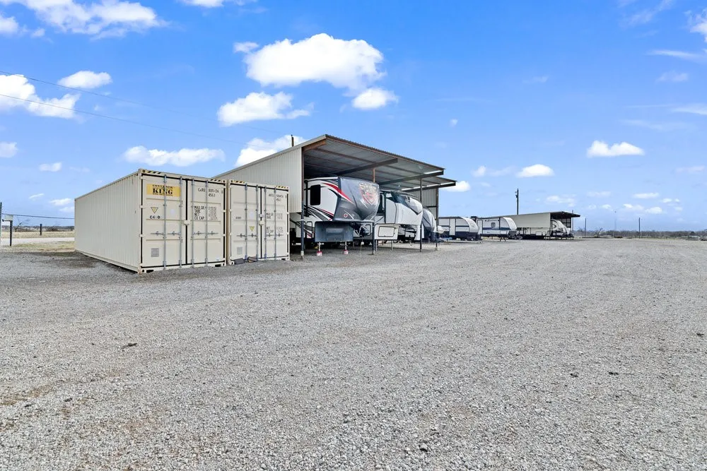 View of parking / parking lot with a carport