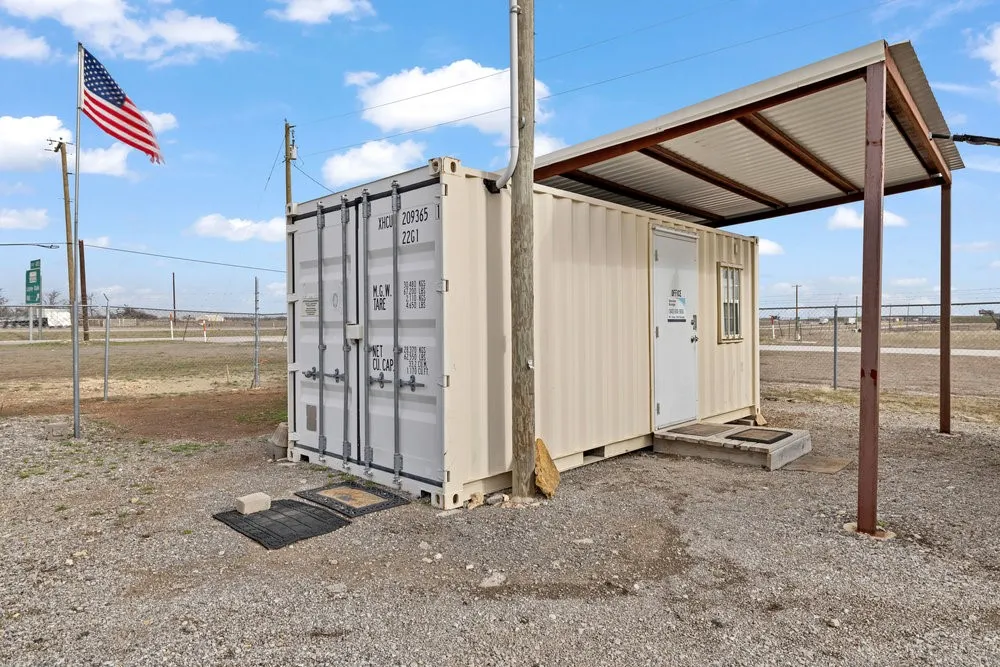 View of outdoor structure with an outbuilding and fence