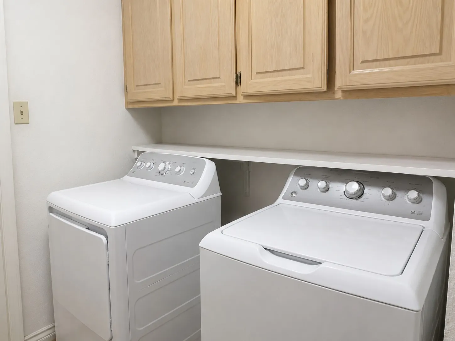 Laundry room with washing machine, dryer and cabinet space