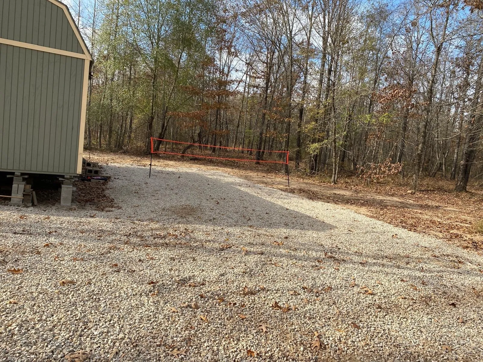 View of yard featuring volleyball court and a view of trees
