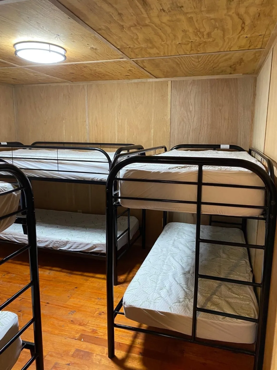 Bedroom with wooden ceiling, wood walls, and hardwood / wood-style flooring