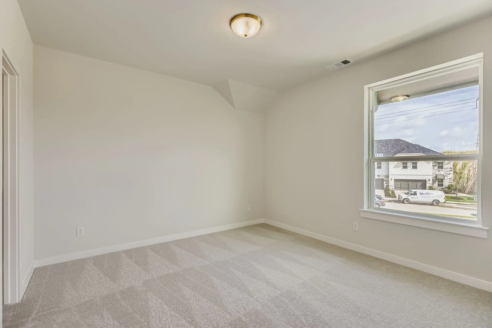 Empty room featuring light carpet and baseboards