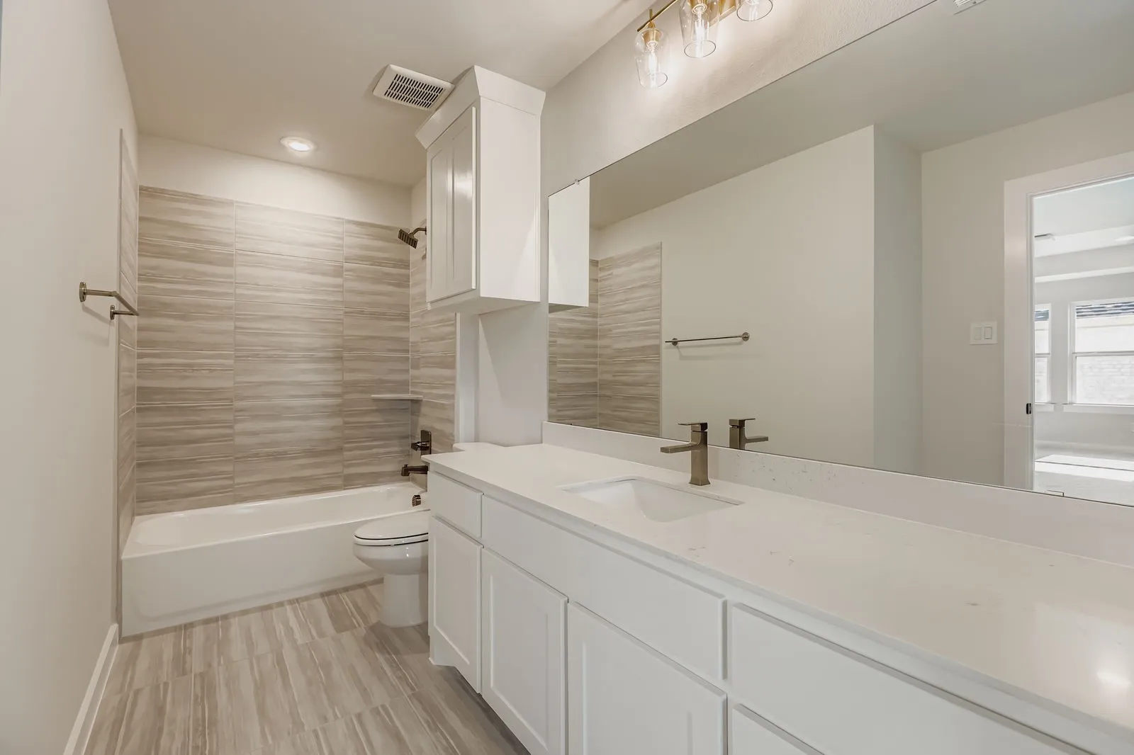 Bathroom featuring vanity, bathtub / shower combination, and recessed lighting