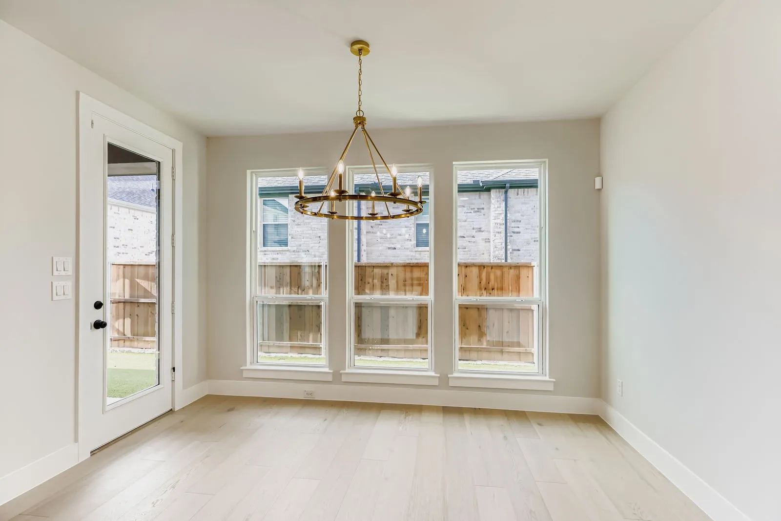 Unfurnished dining area with a chandelier and light wood-style floors
