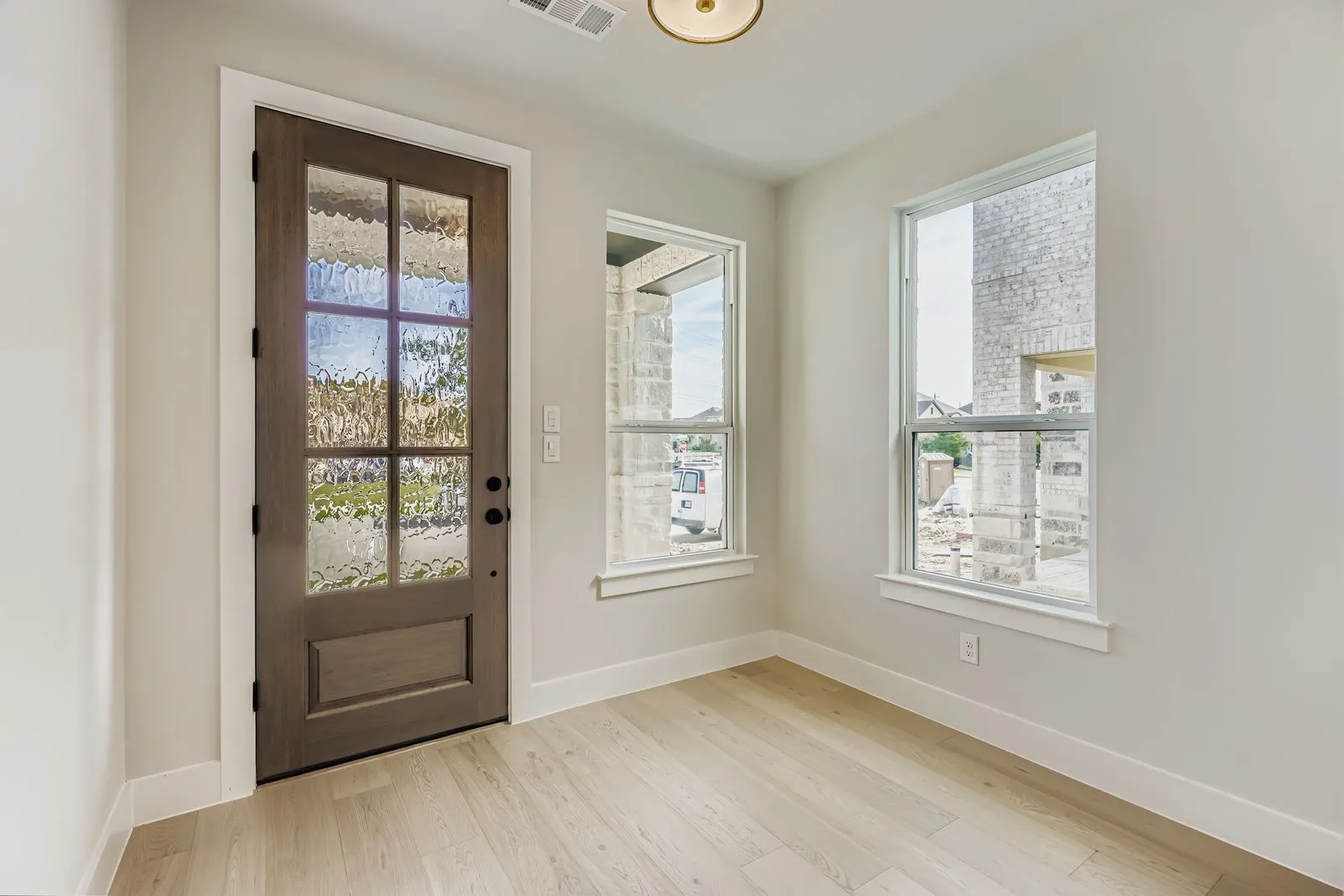 Entrance foyer with healthy amount of natural light and light wood-type flooring