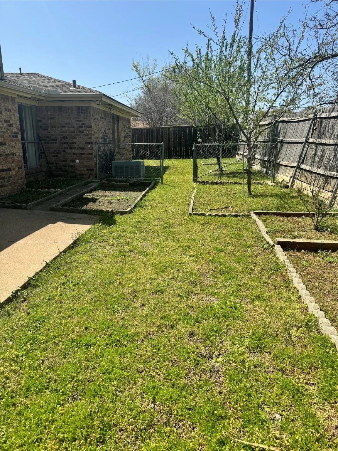 View of yard featuring a fenced backyard and central AC unit
