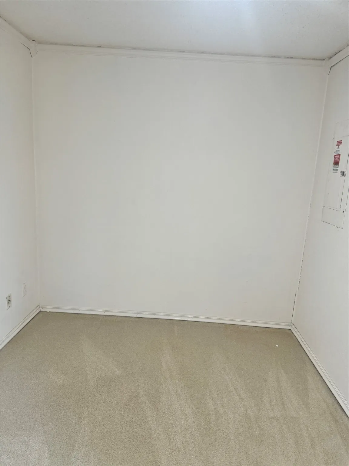 Unfurnished room featuring light carpet