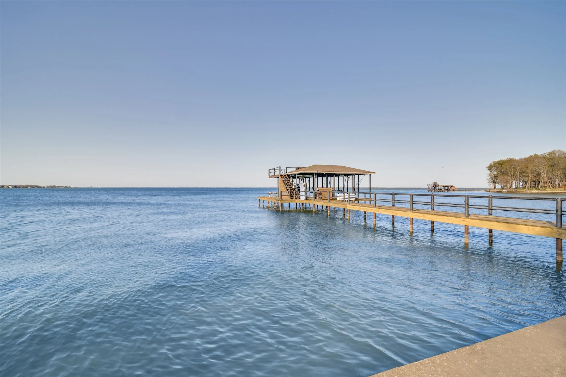 Dock area with a open water view and steel retaining wall and walk way