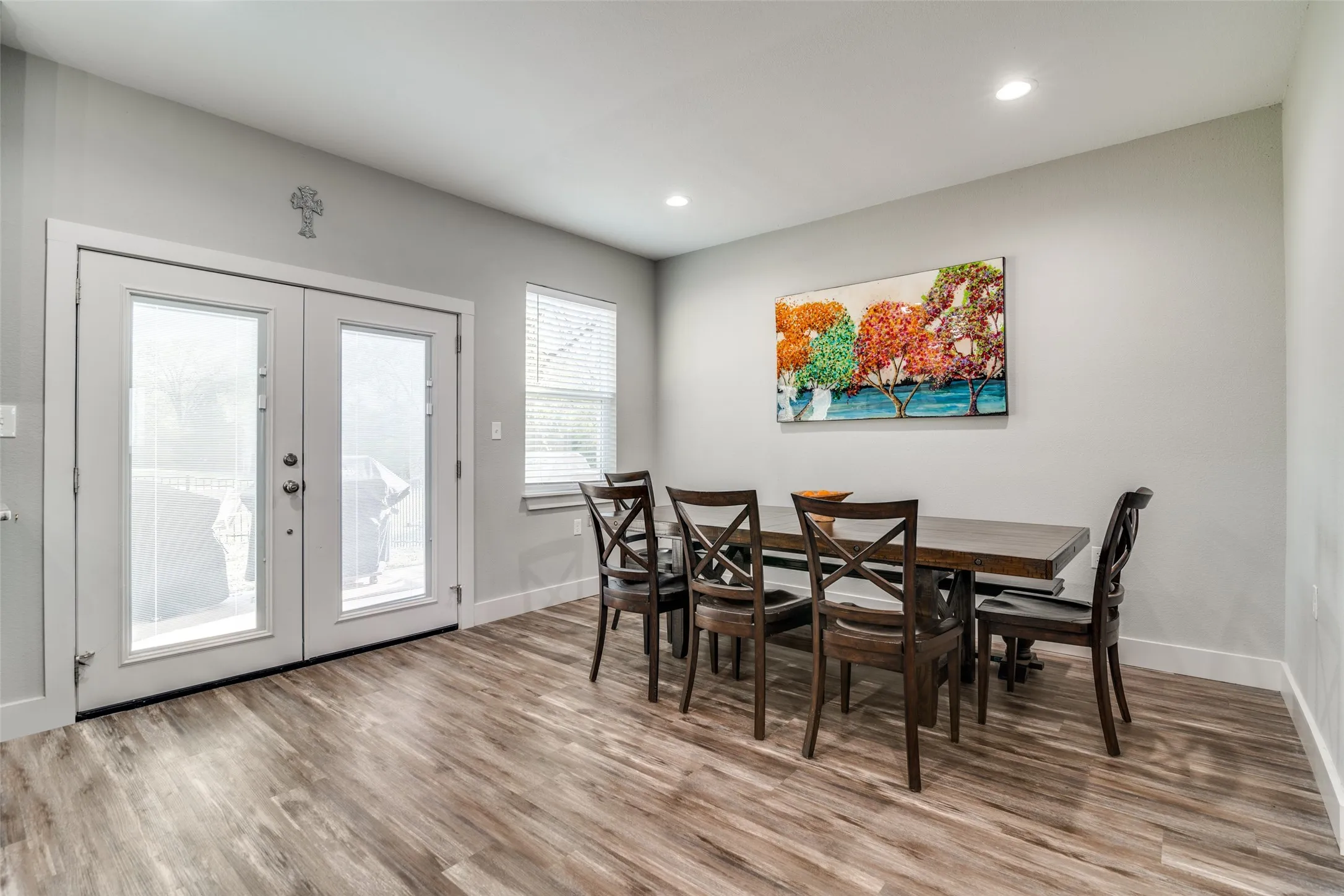 Dining space with french doors, wood finished floors, baseboards, and recessed lighting