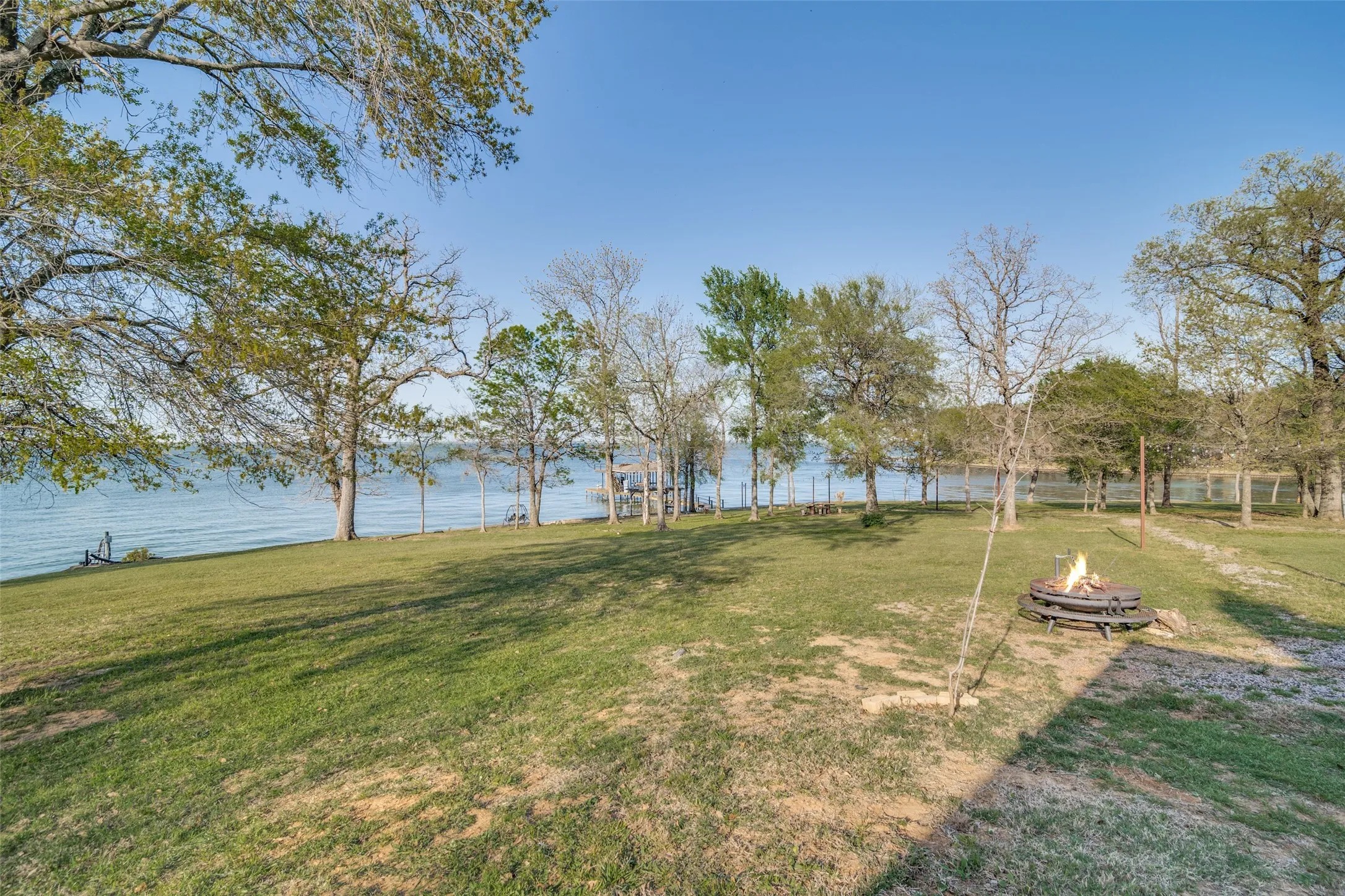 View of yard featuring an outdoor fire pit and open water view and cove