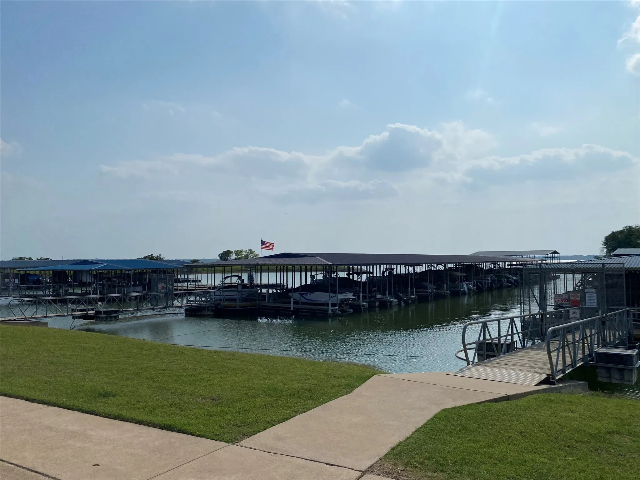 Dock area with a water view and a yard