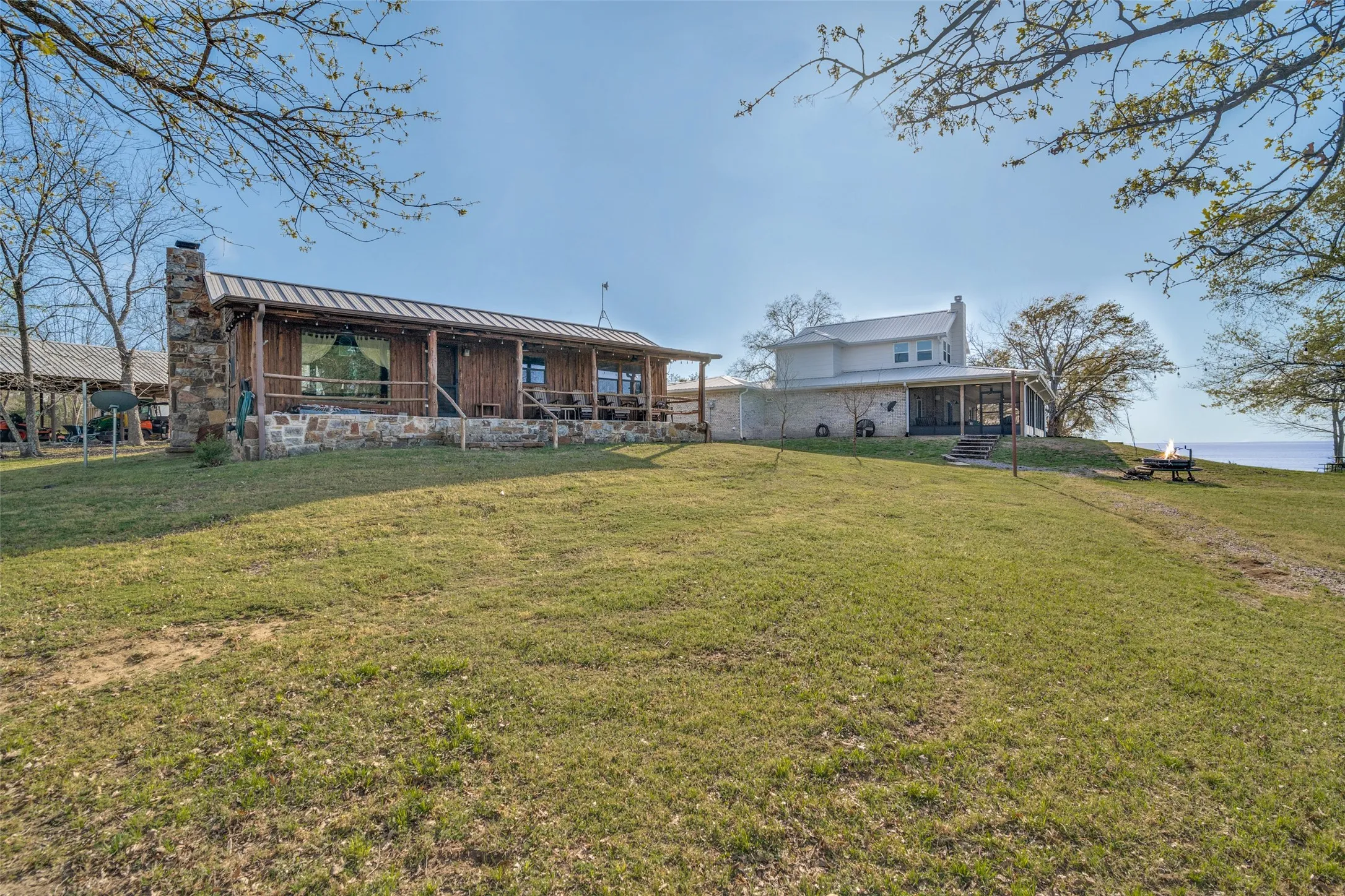 Back of property with a yard and lake view
