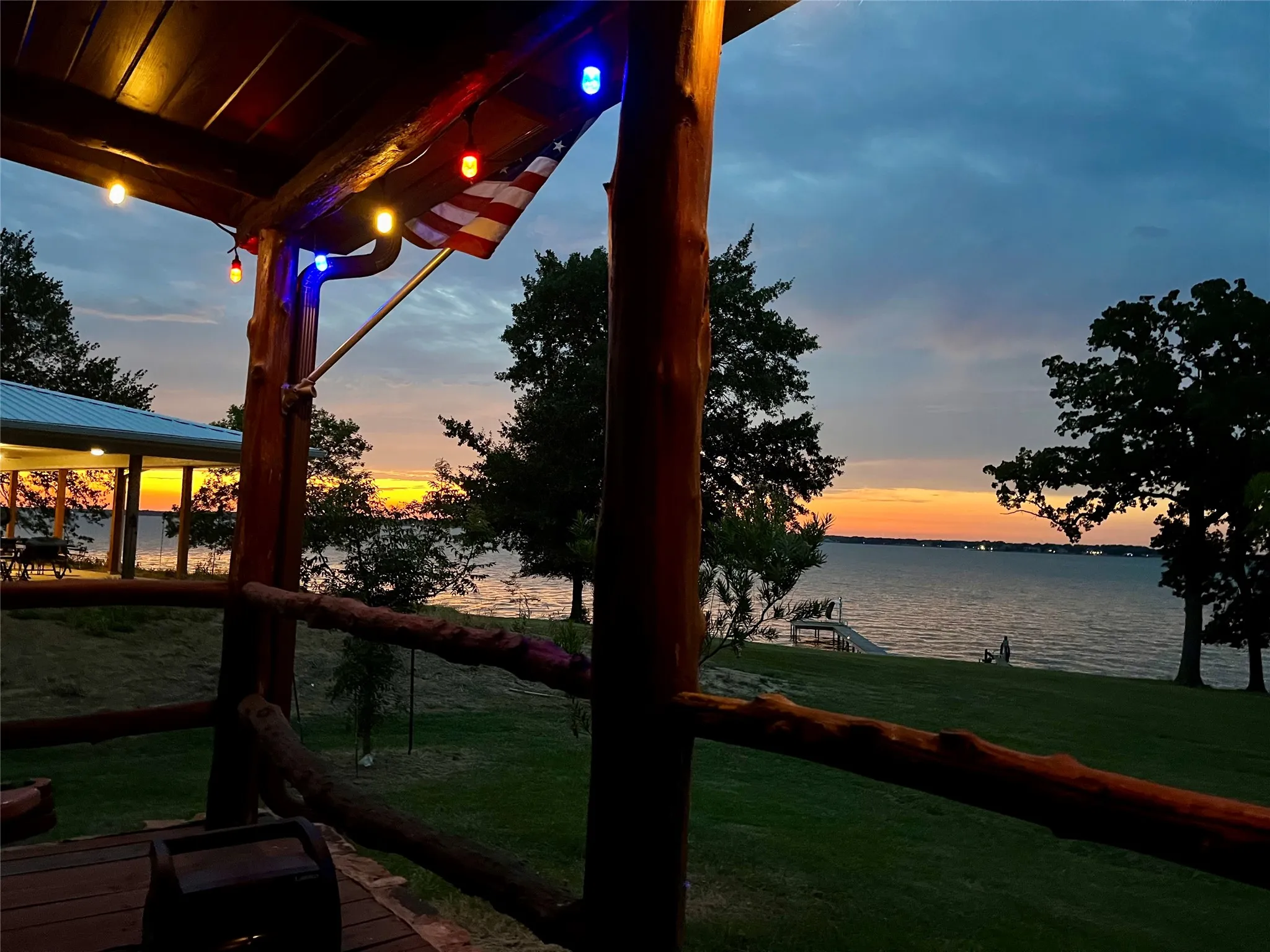 Yard at dusk featuring a water view from cabin