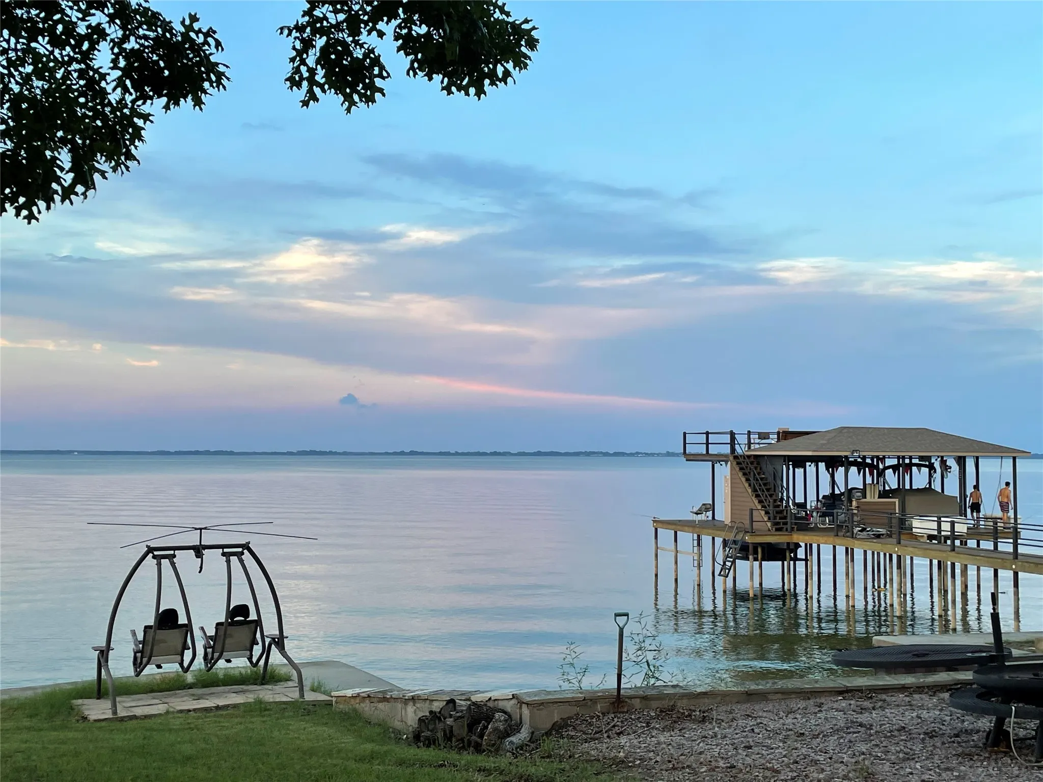 View of dock featuring boat lift and a water view