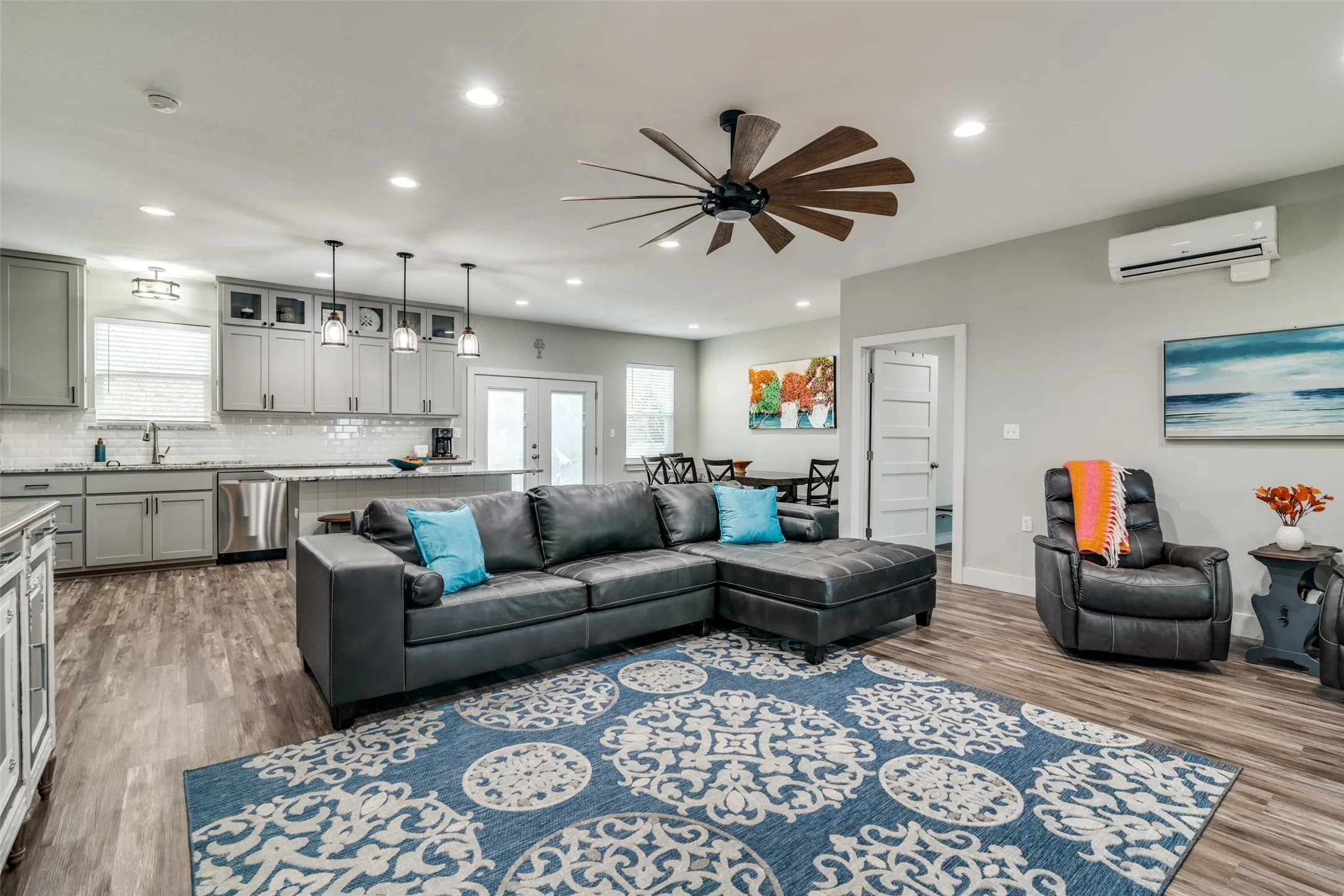 Open floor plan with ceiling fan, wood finished floors, and recessed lighting