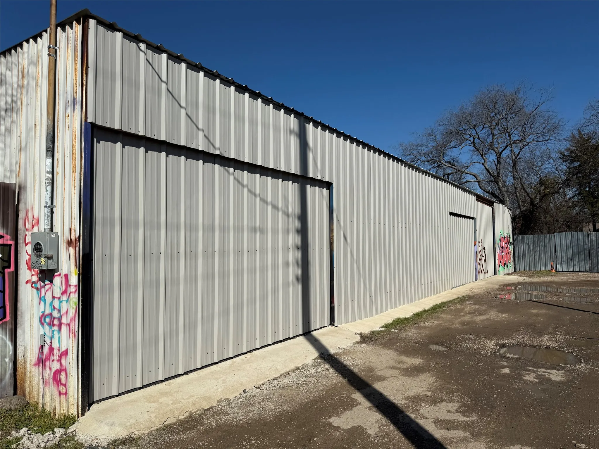 View of pole building with fence