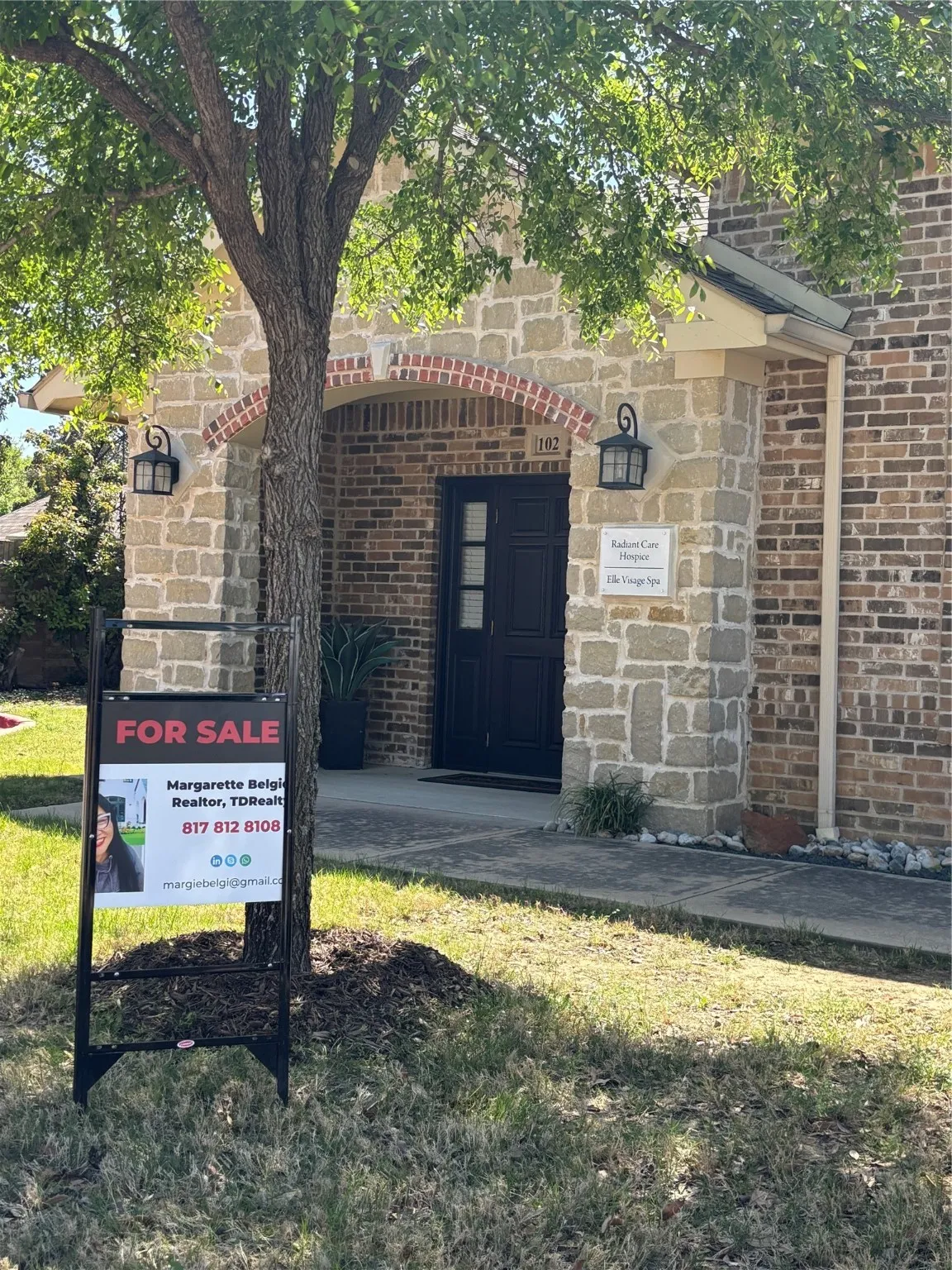 Property entrance featuring brick siding