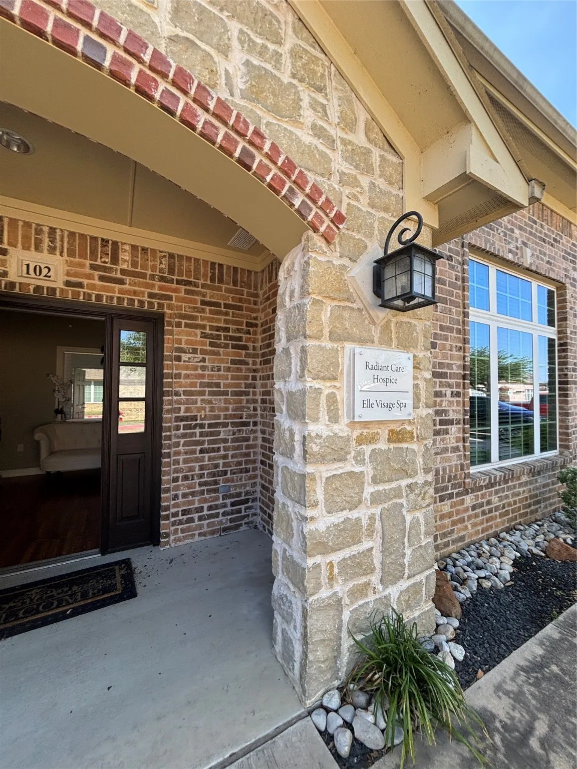 Entrance to property featuring brick siding