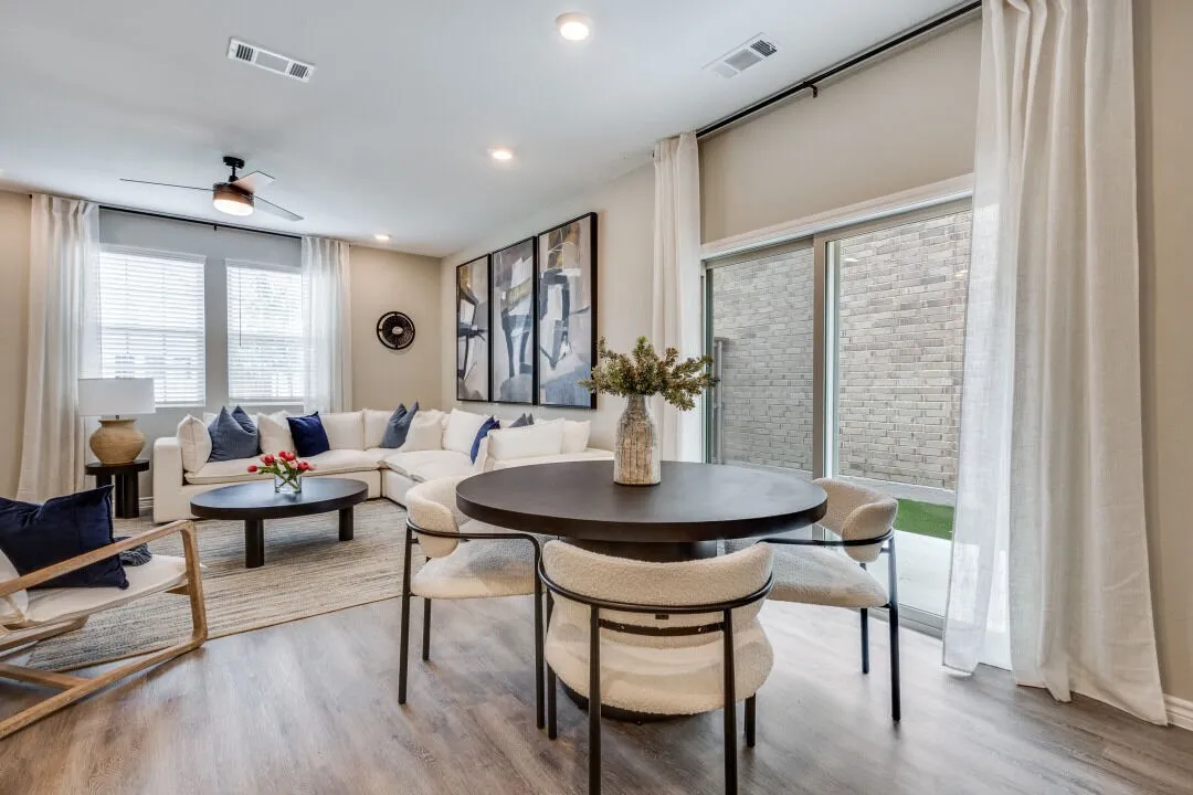 Dining area with visible vents, wood finished floors, and a ceiling fan