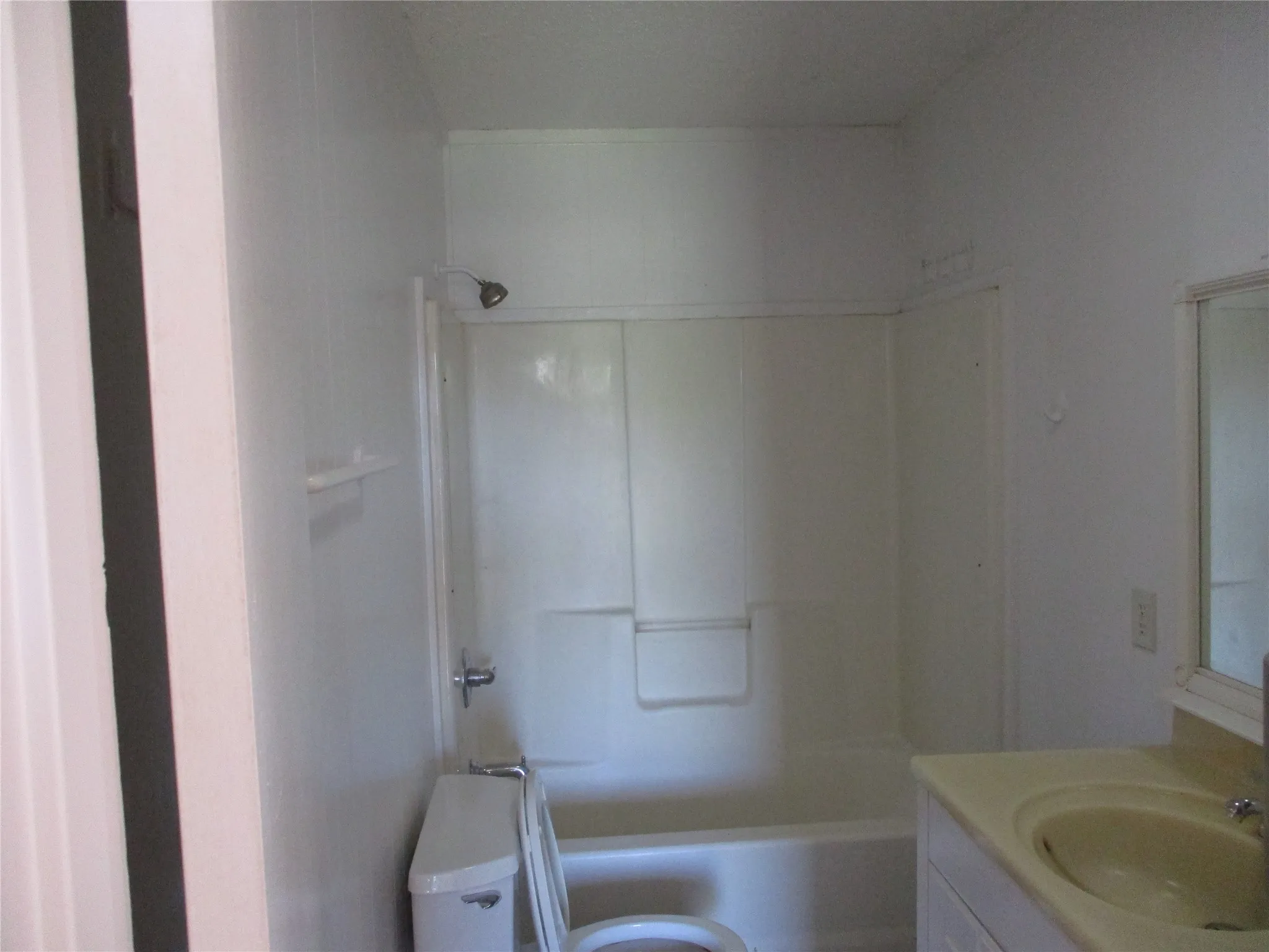 Bathroom featuring toilet, bathing tub / shower combination, and vanity