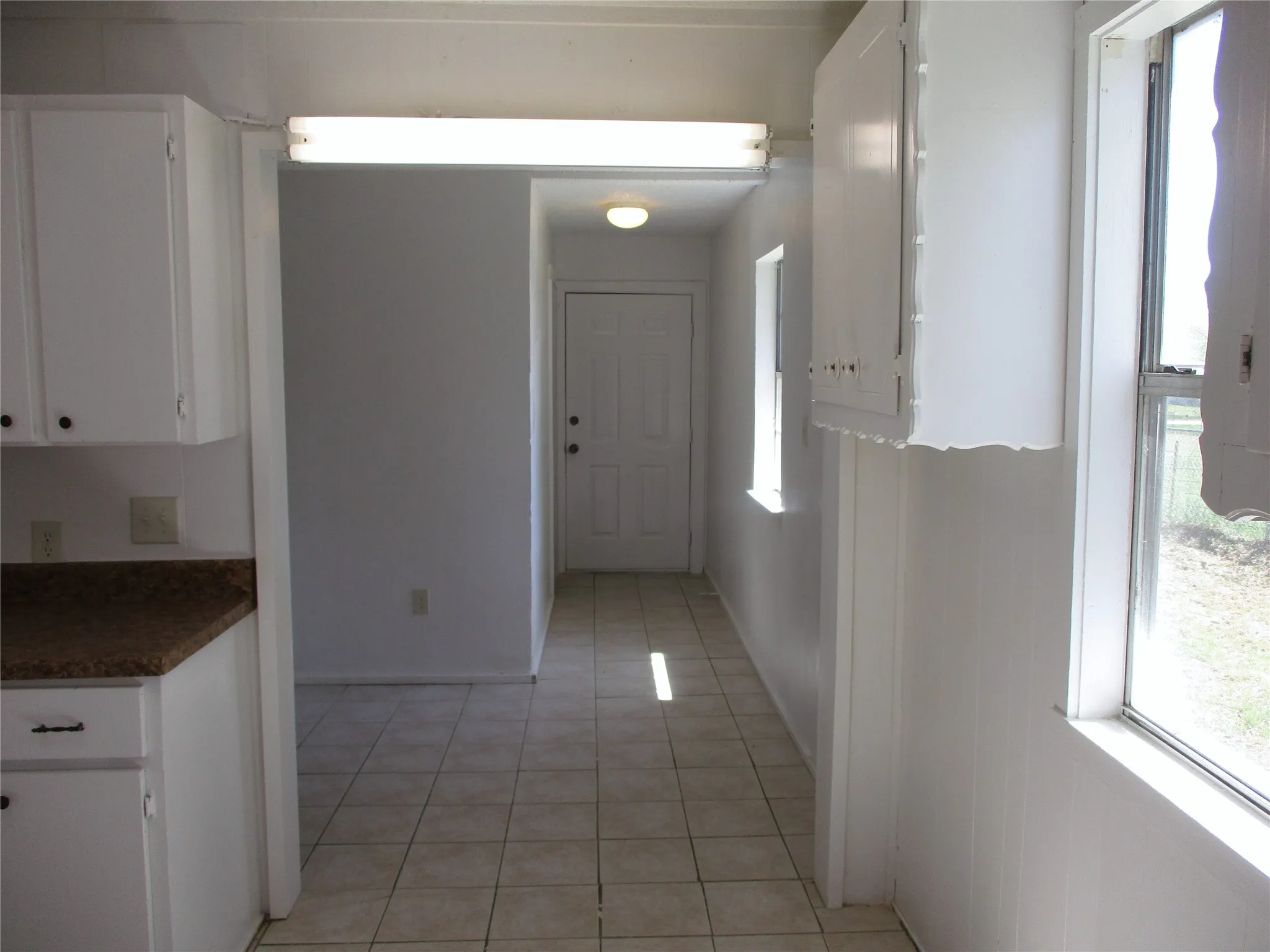 Hallway with light tile patterned floors