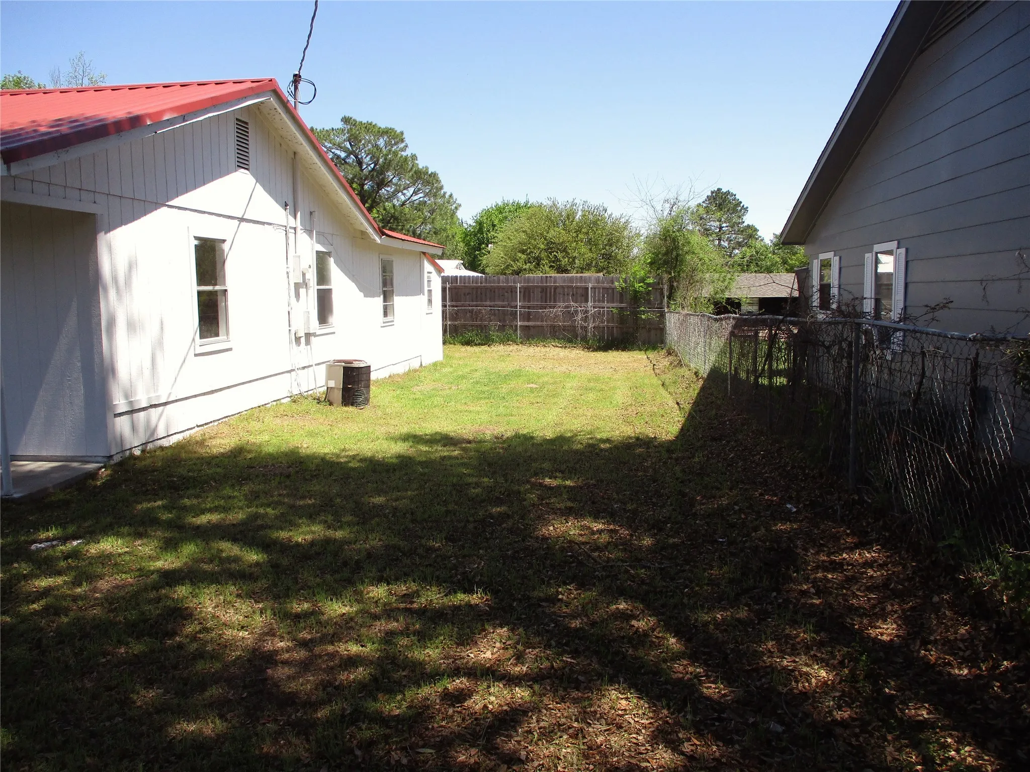 View of yard featuring cooling unit and a fenced backyard
