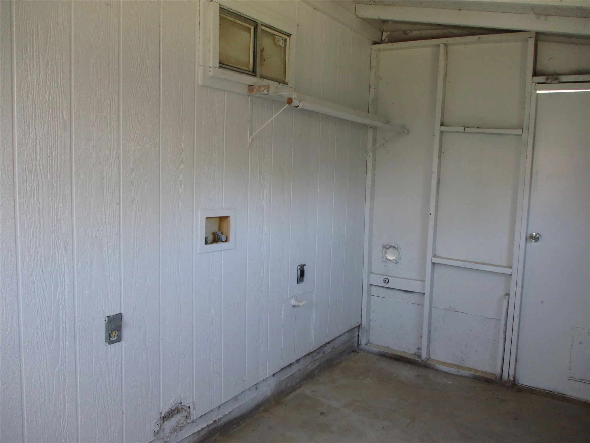 Laundry area featuring hookup for an electric dryer, wooden walls, laundry area, and washer hookup