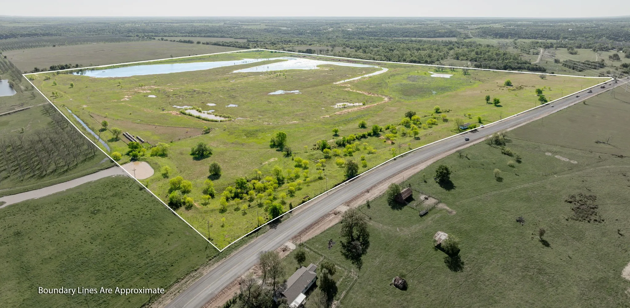 Birds eye view of property with a water view and a rural view