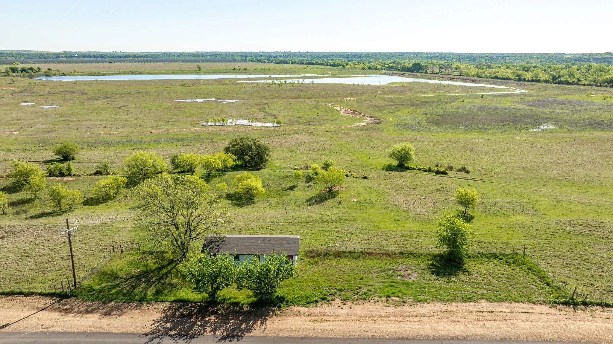 Drone / aerial view with a water view and a rural view